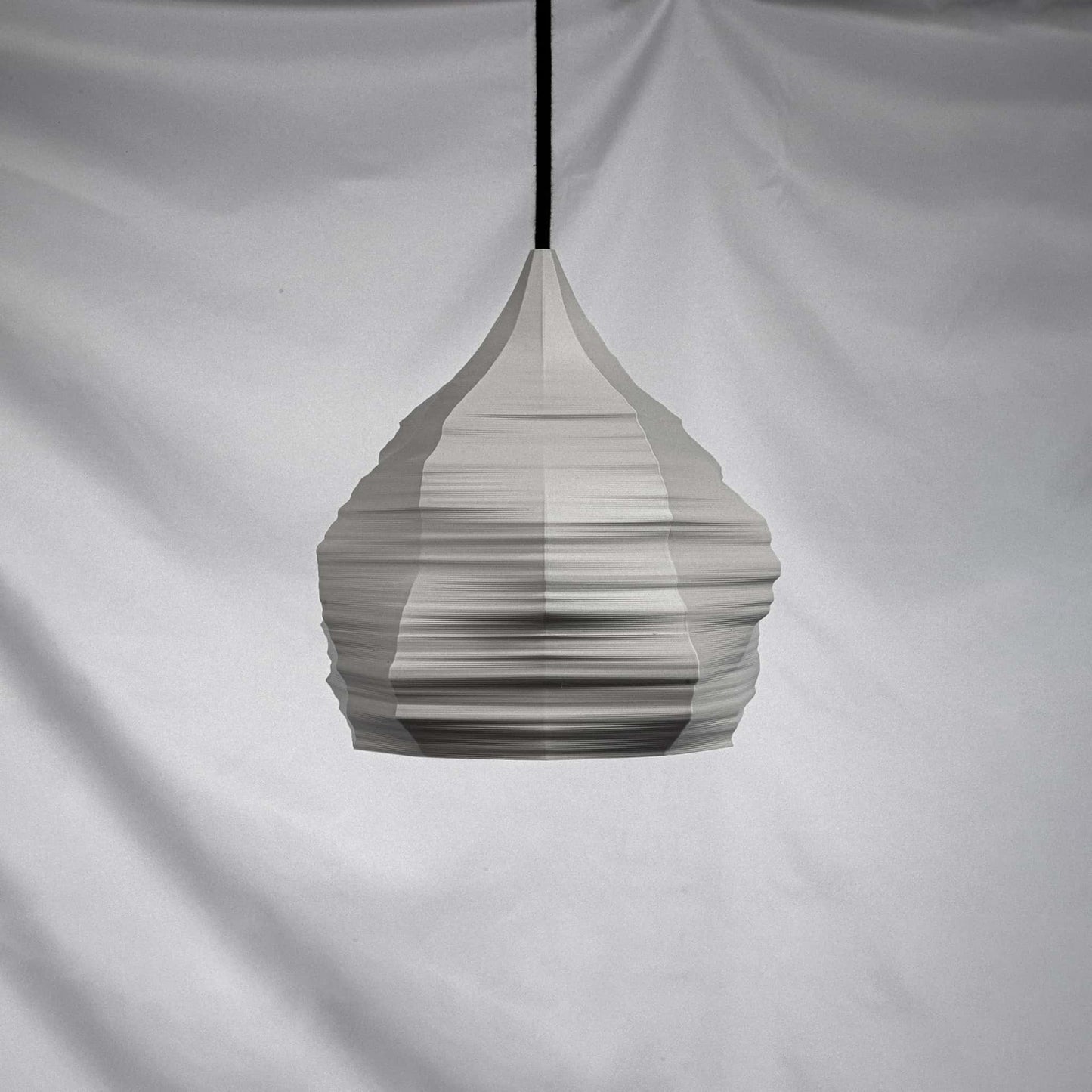 Dunalia 3d printed lamp suspended with black textile cable and light off