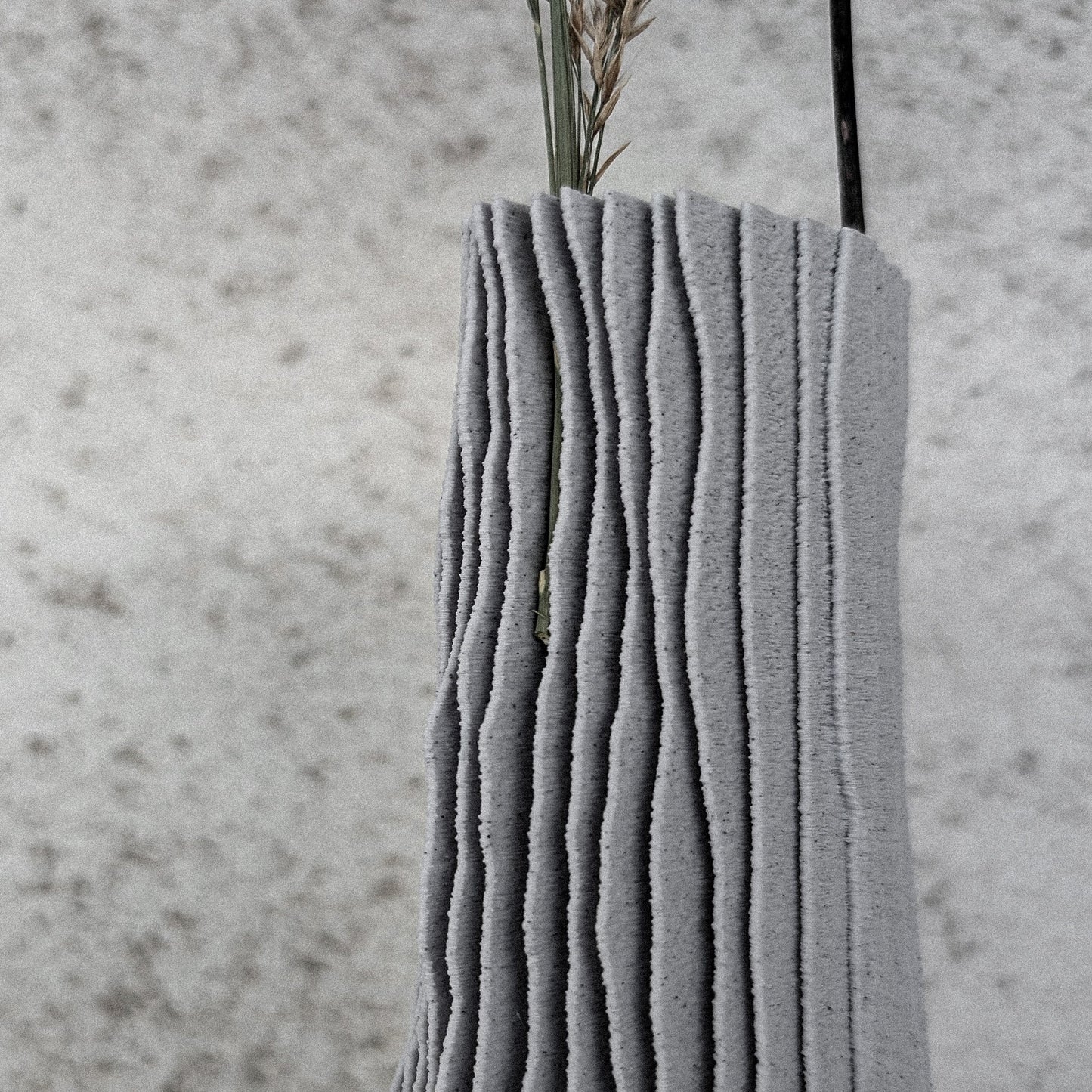 modern 3d printed vase CARSIA close-up with dried grass stems, showing karst-inspired ridges