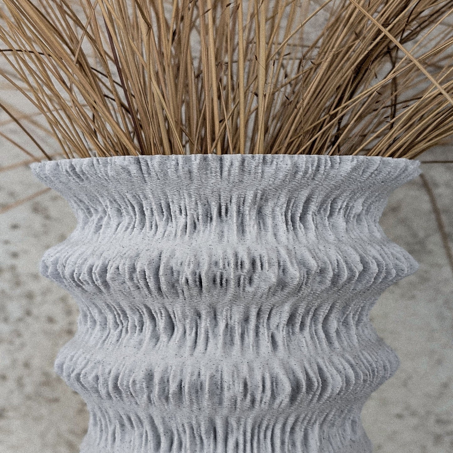FLUVIA vase styled with dried grass against stone wall