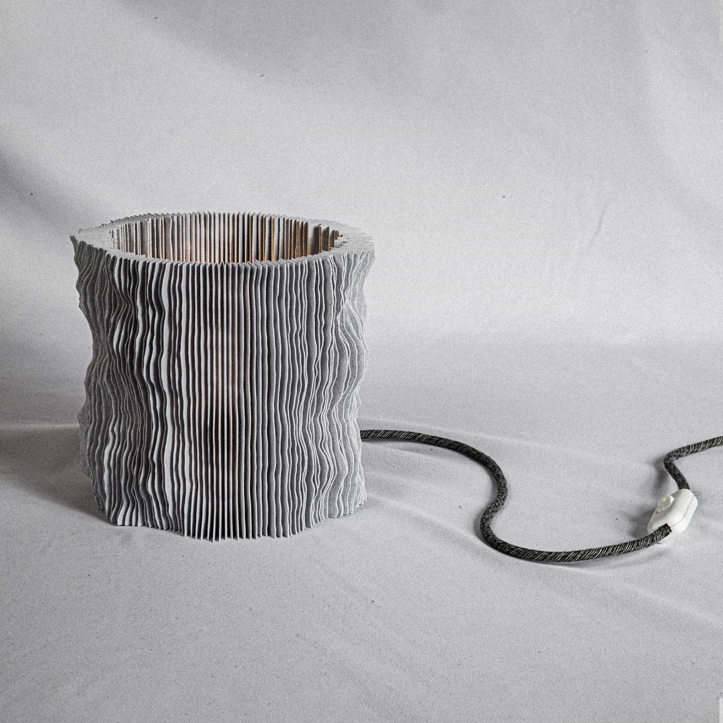 Close-up of PROFILUM Lamp ridged surface with warm LED glow highlighting the folds