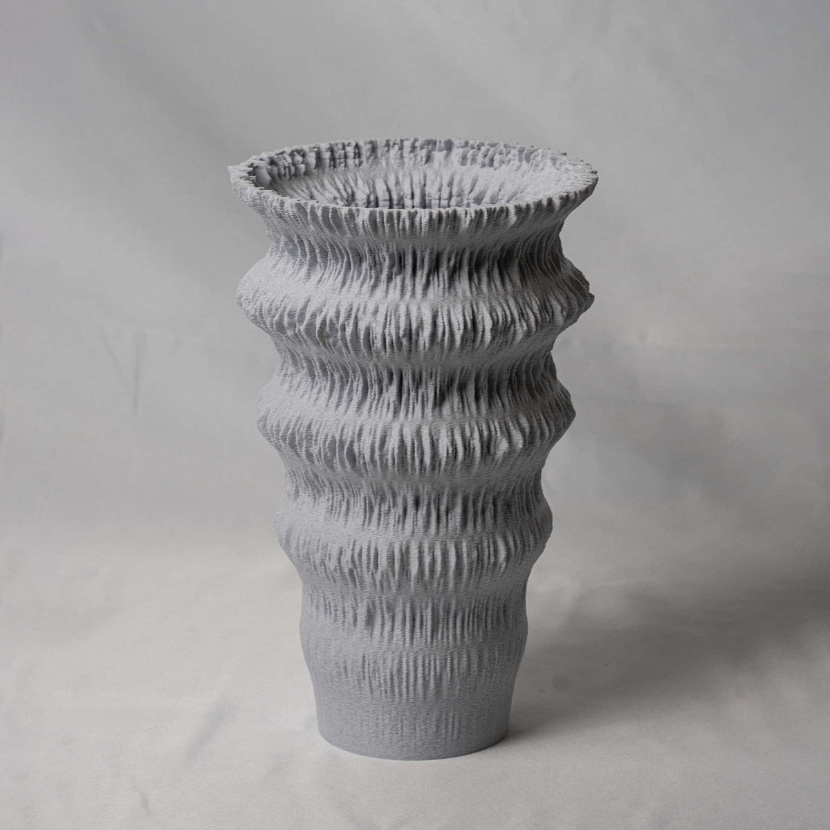 Textured gray vase on a light gray background