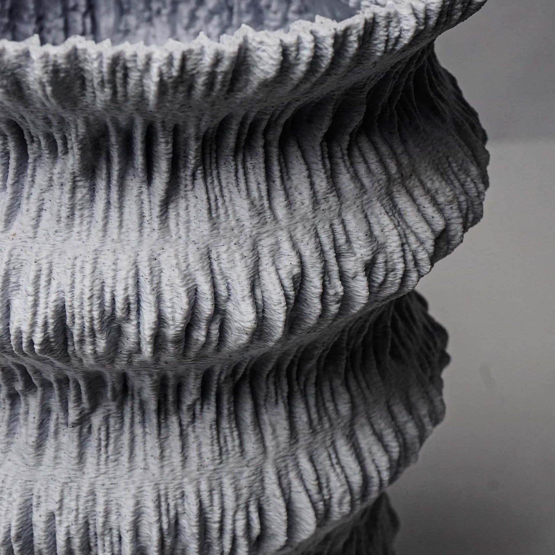 textured gray vessel on a neutral background