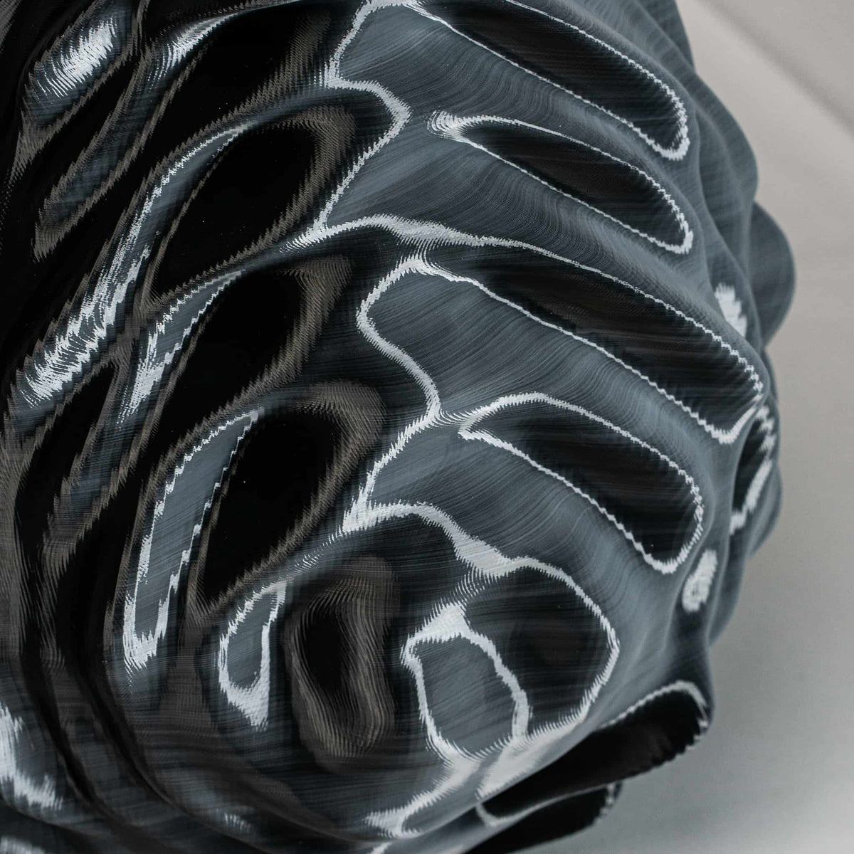 Close-up of a textured black and gray vase