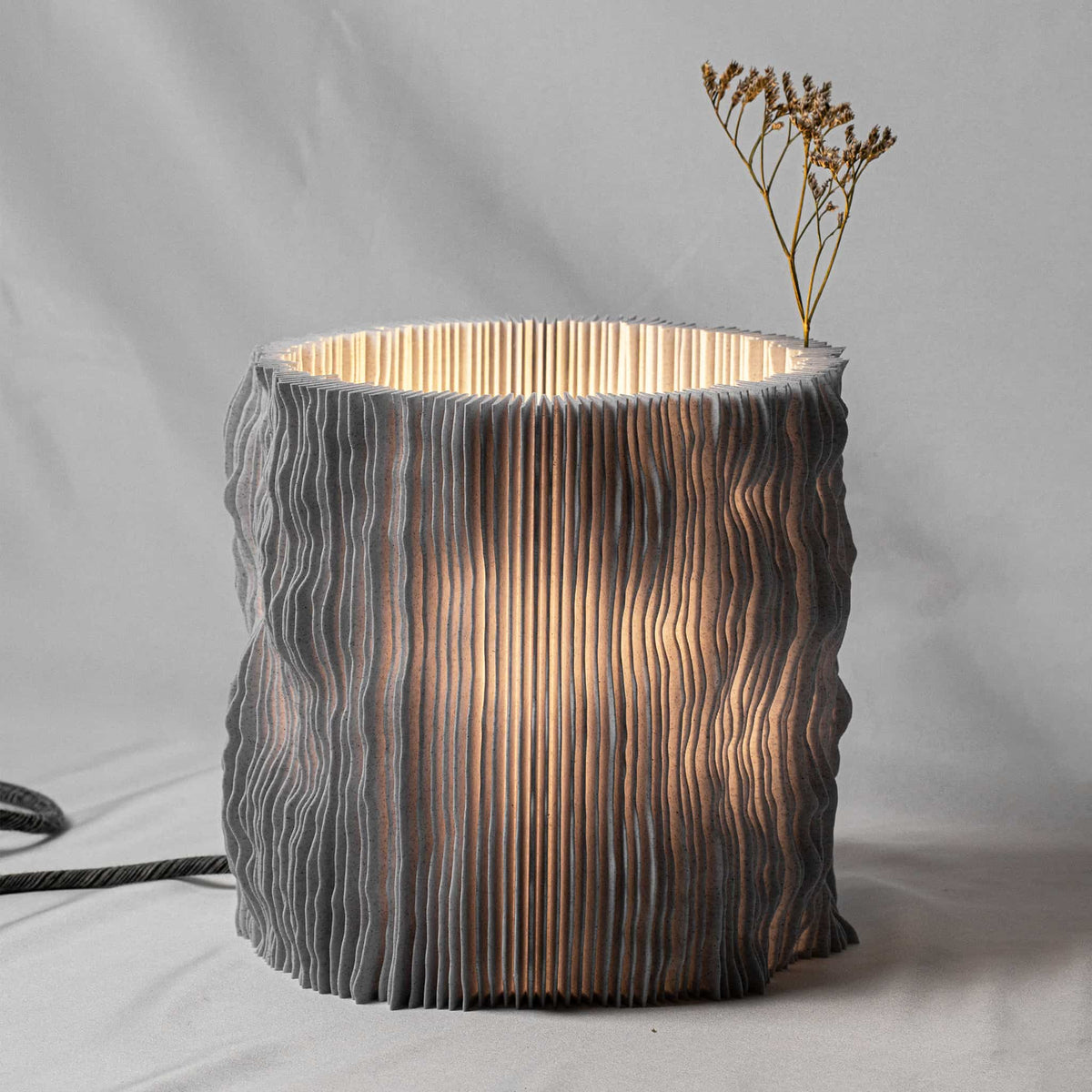 Textured lamp with wavy pattern on a neutral background