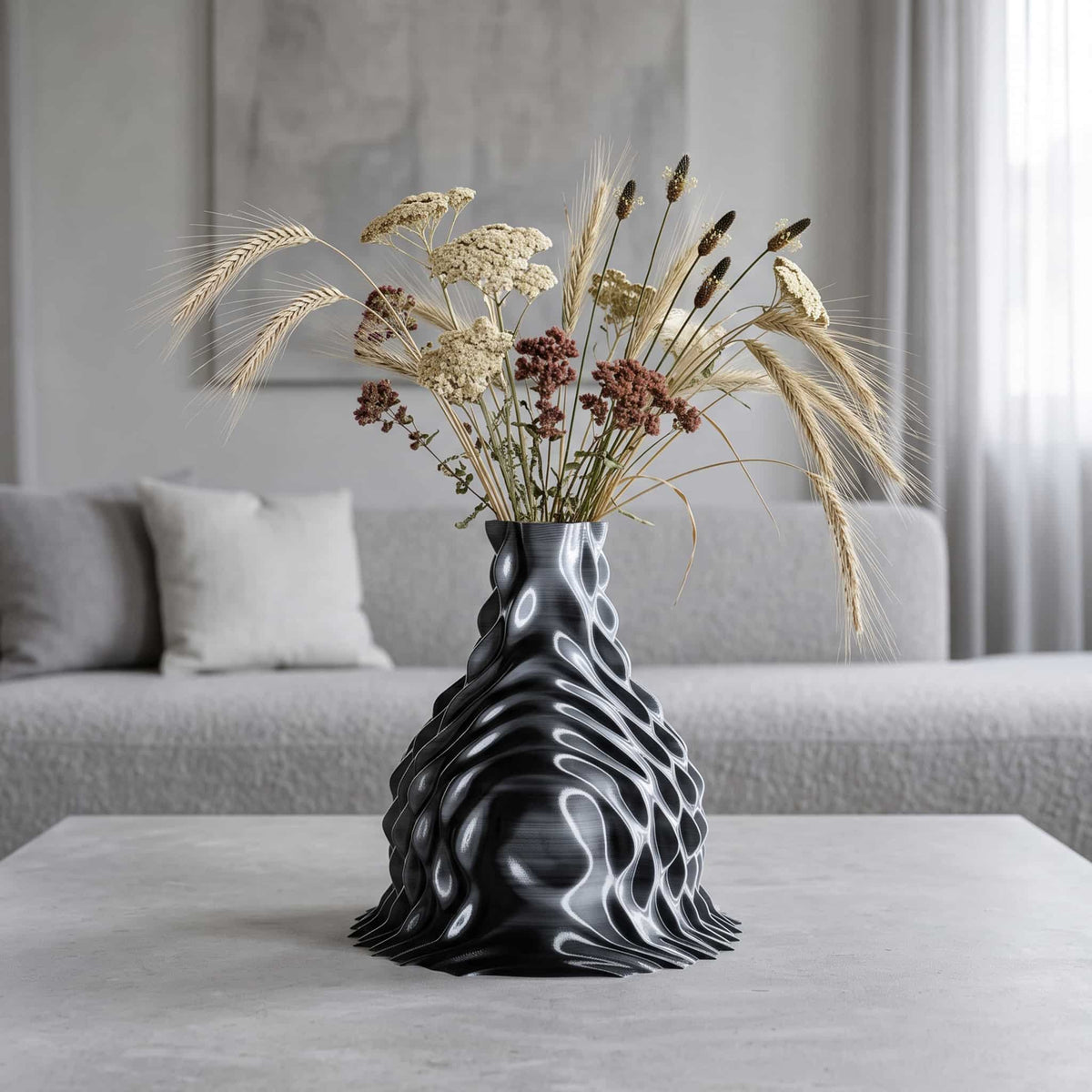 ONDA Diffraction 3D-printed vase, flared black and white form with dried wheat and yarrow on a living room coffee table