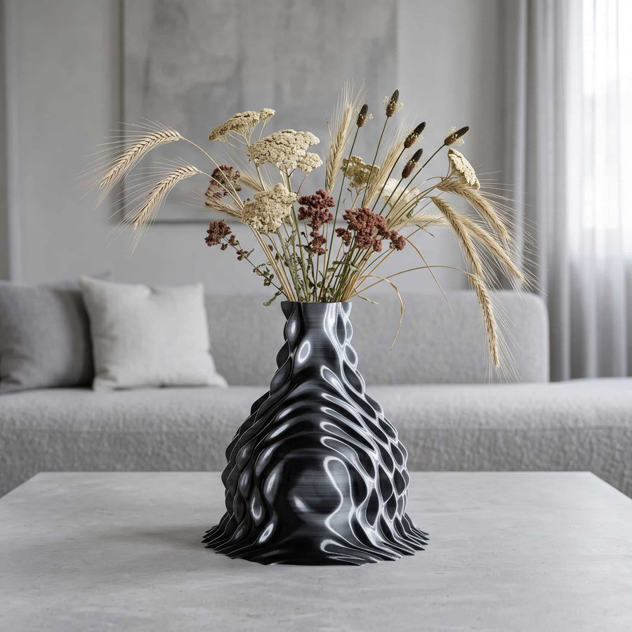ONDA Diffraction 3D-printed vase, flared black and white form with dried wheat and yarrow on a living room coffee table