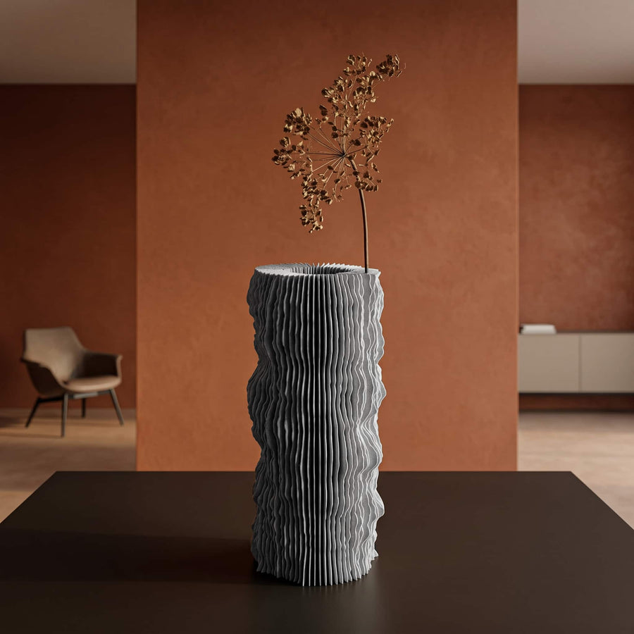 Profilum vase with a flower inside his folds on a table with a orange brown background wall